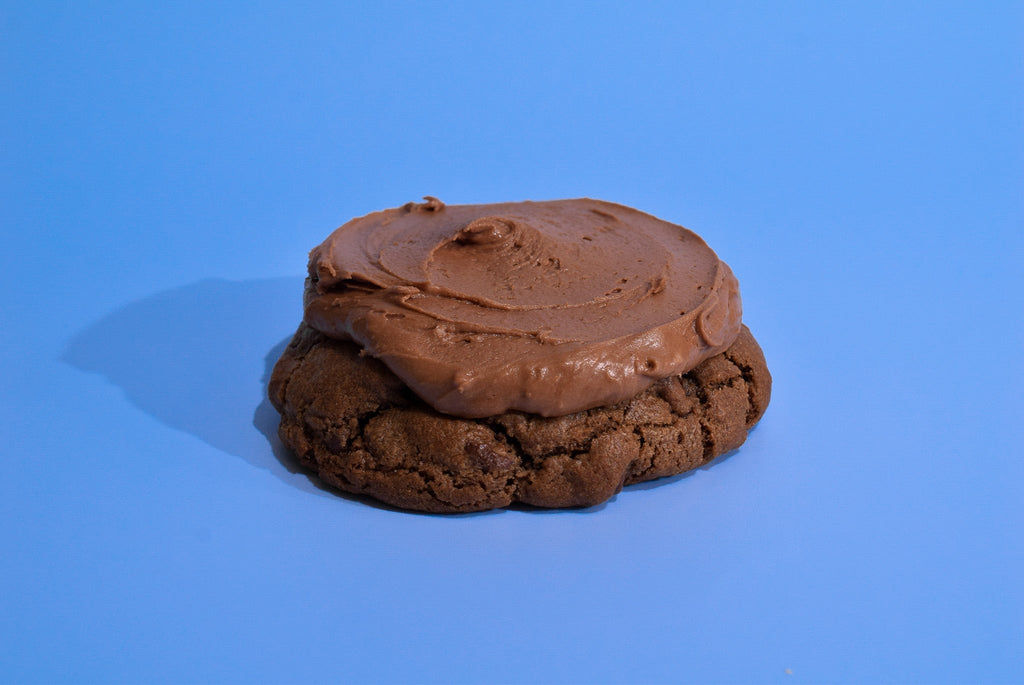 A Texas Sheet Cake cookie on a blue background.