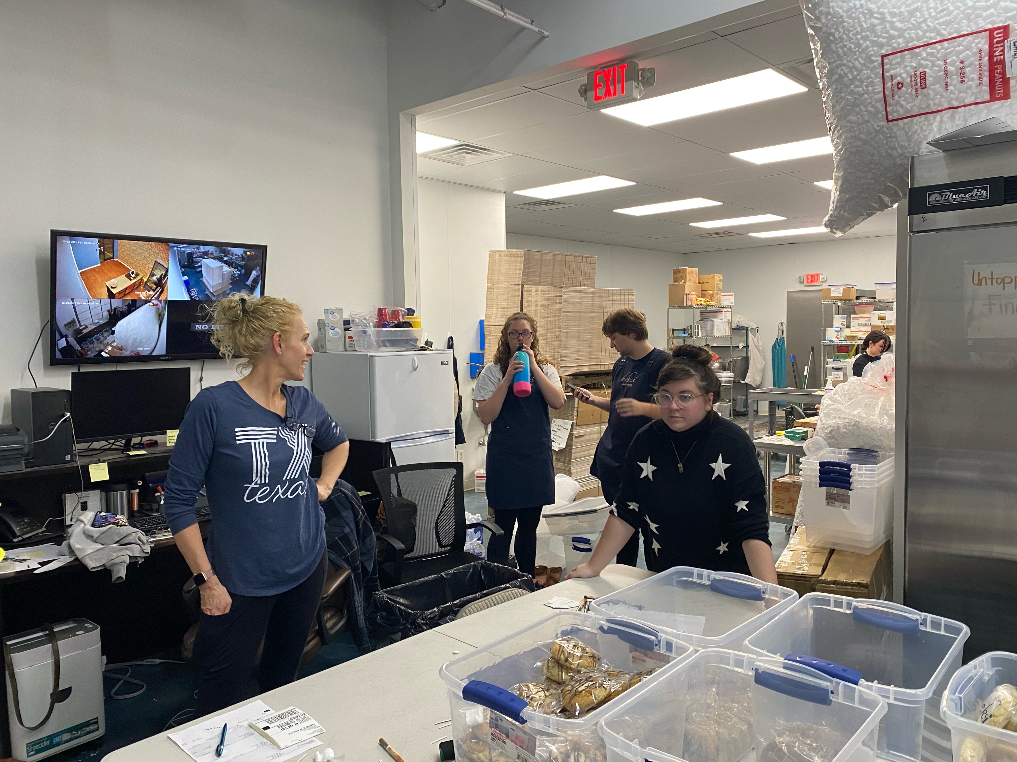 Employees at keksi cookie packing and working in the kitchen.