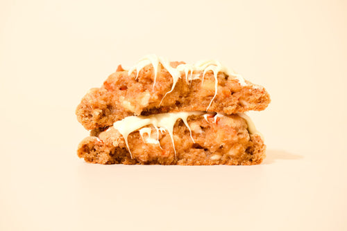 Two Carrot Cake cookies stacked, icing drizzle running over the edges