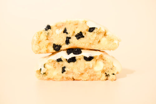 Two stacked Blueberry Lemon cookies on a cream background.