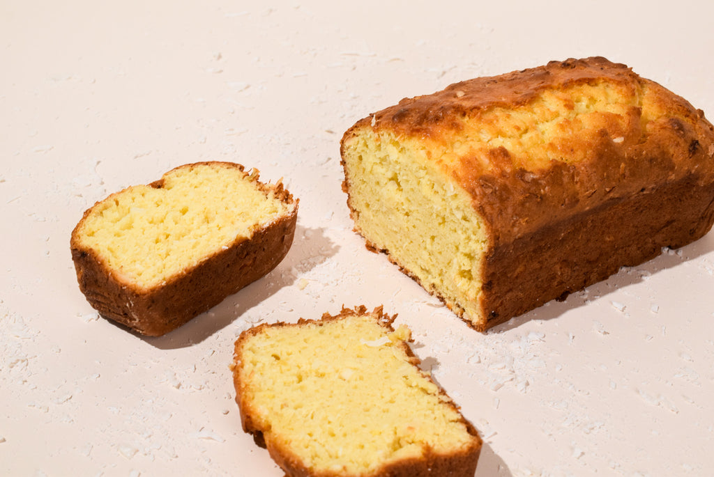 Hawaiian Coconut Loaf with two slices on a light surface