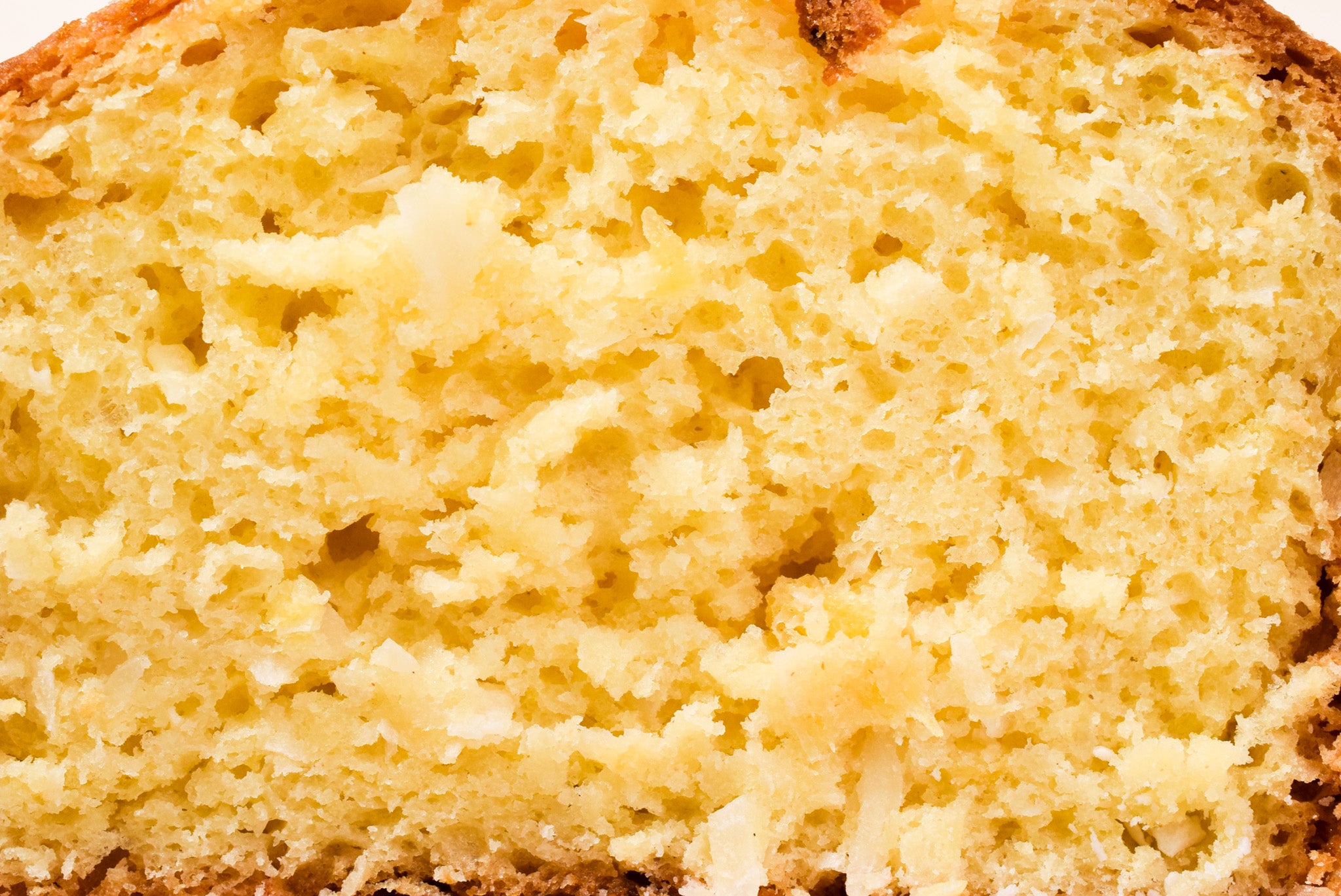 Close-up of a slice of Hawaiian Coconut bread with a porous texture