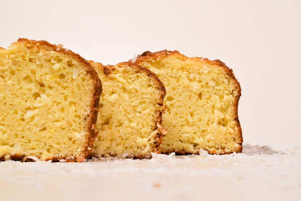 Three slices of Hawaiian Coconut Loaf on a white surface