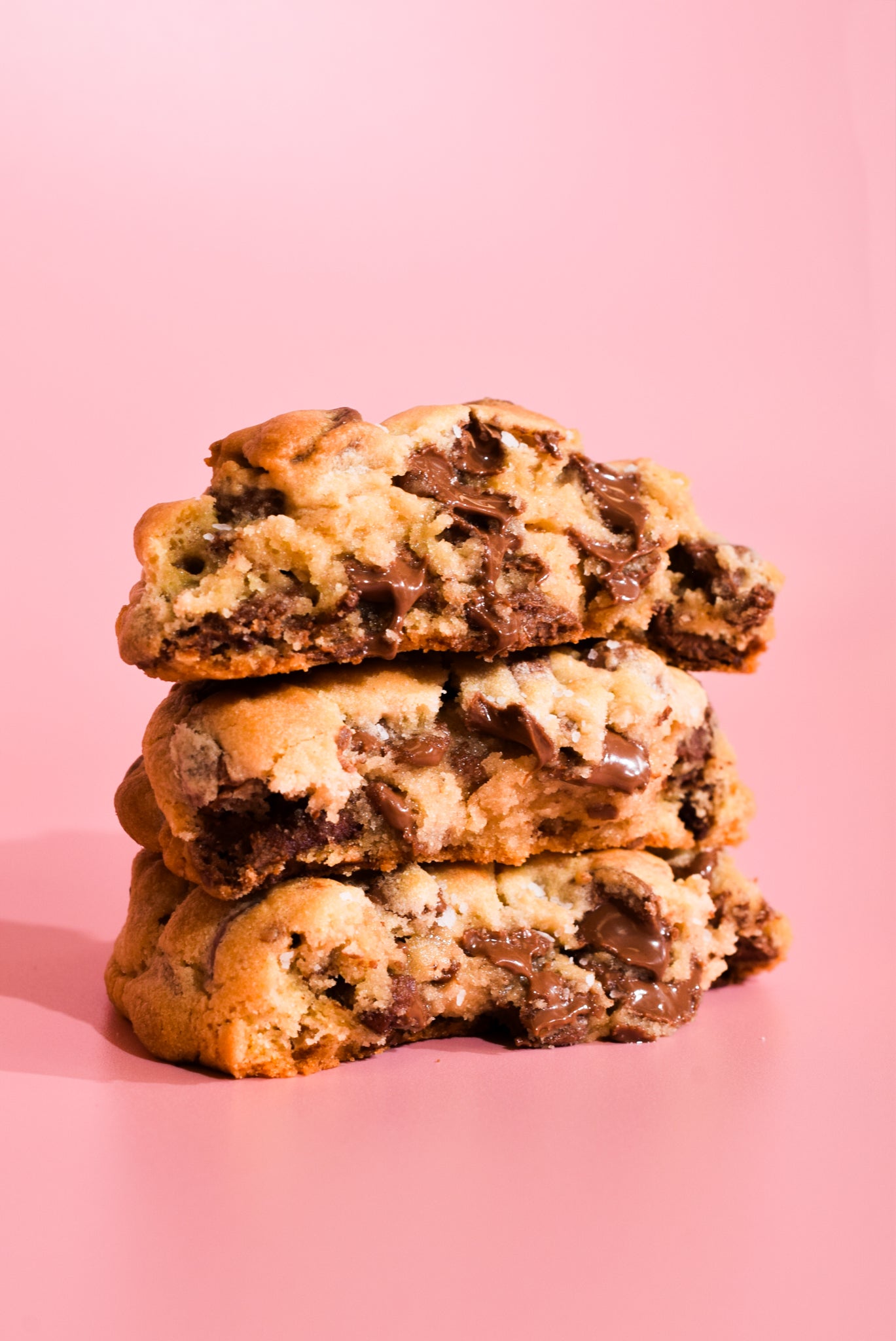 Stack of chocolate chip cookie on a pink background