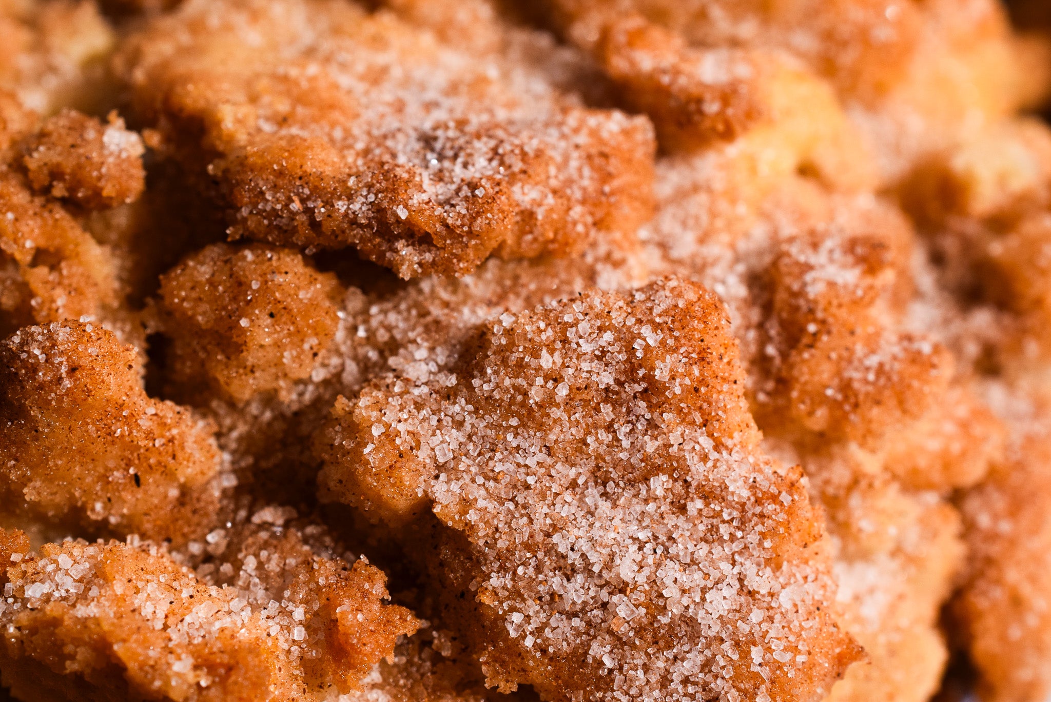 Close-up of a crumbly, sugary dessert with a brown color.
