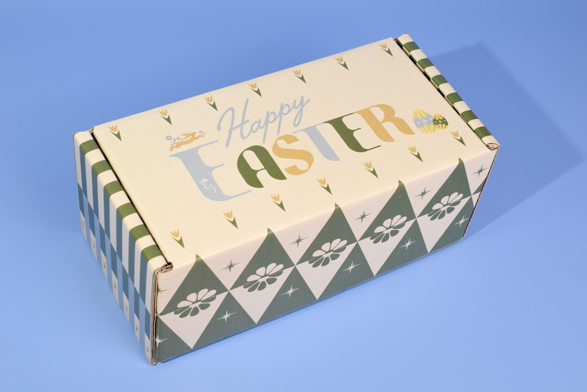 The Easter themed cookie box on a blue background.