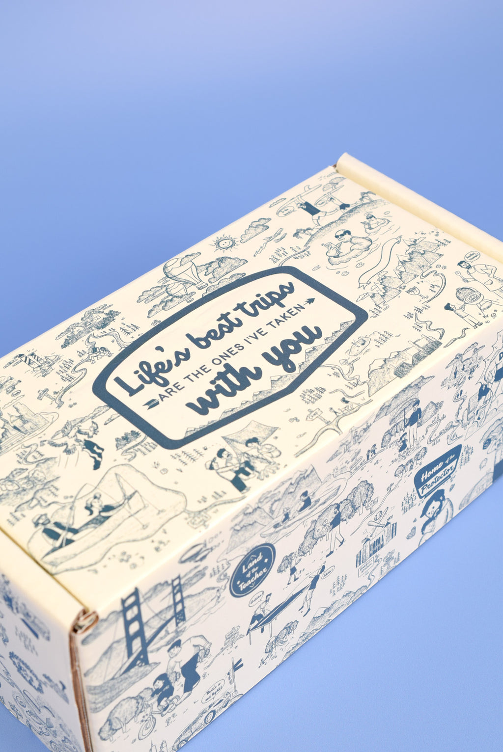 A keksi Father's Day cookie box with travel themed illustrations on a blue background.