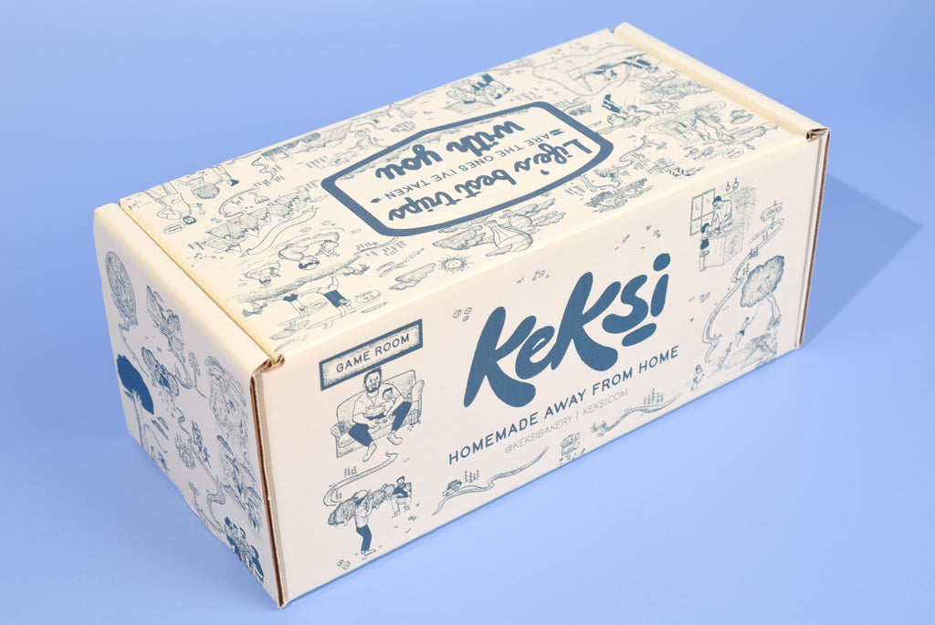 A keksi Father's Day cookie box with travel themed illustrations on a blue background.