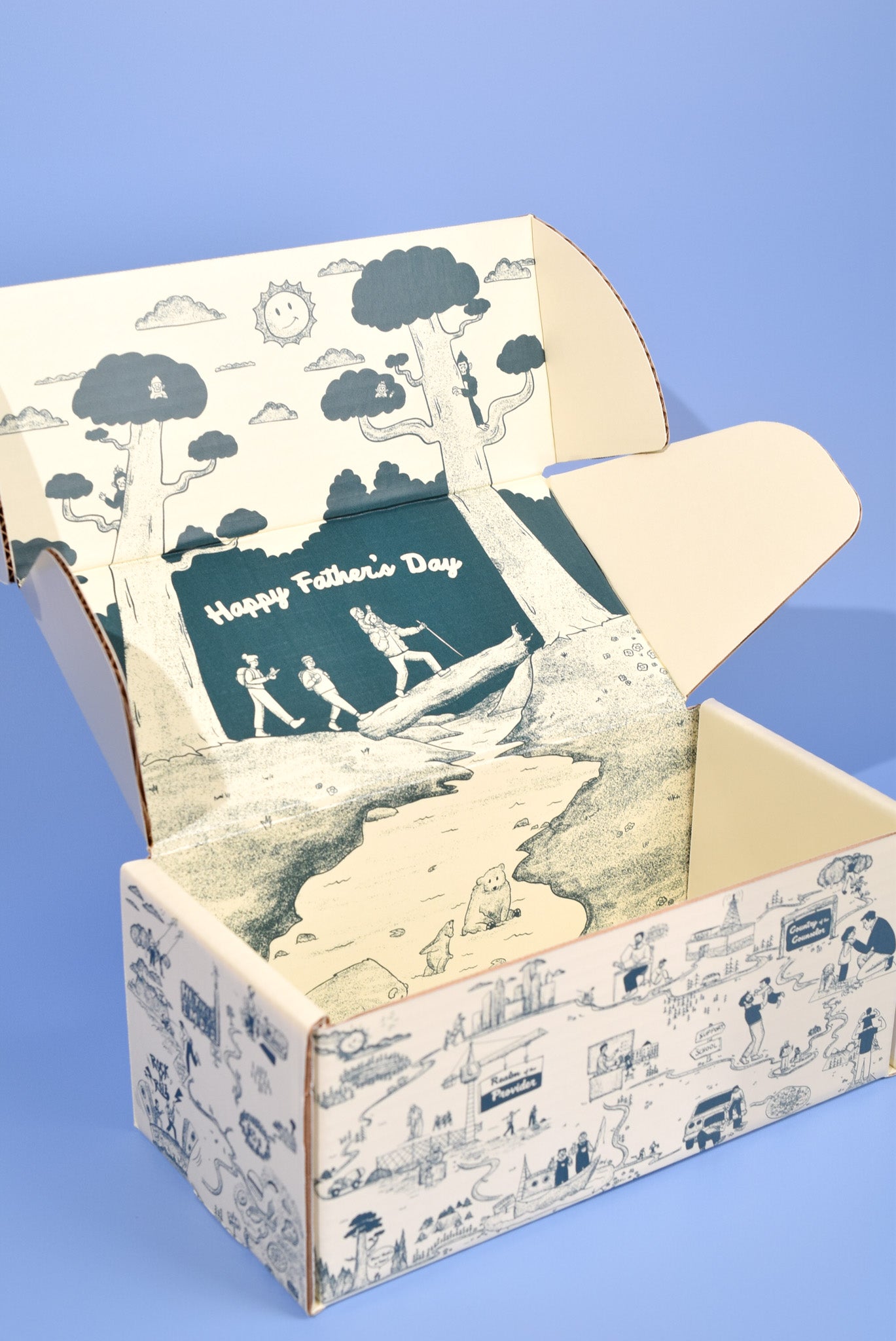 A keksi Father's Day cookie box with travel themed illustrations on a blue background.