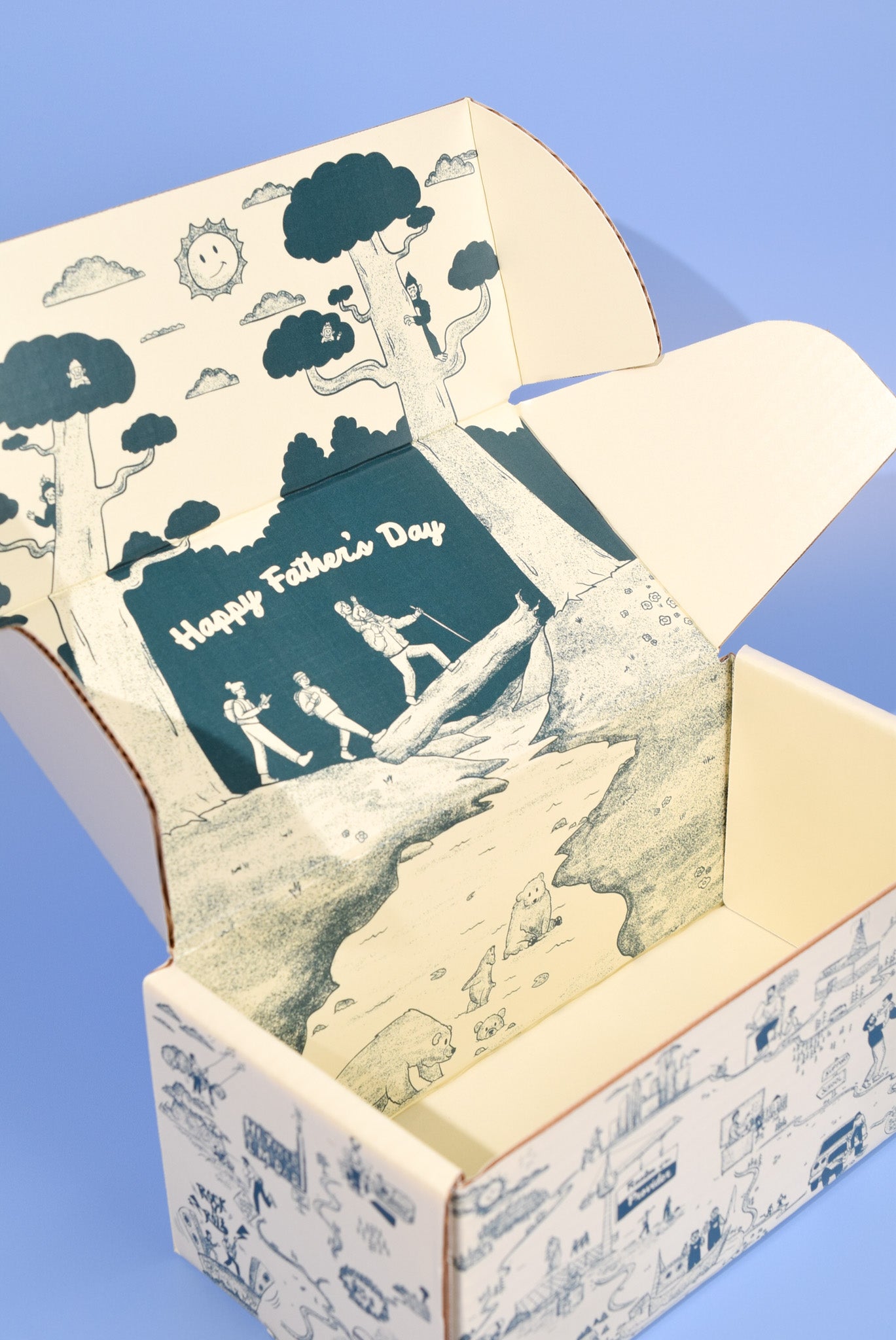 A keksi Father's Day cookie box with travel themed illustrations on a blue background.