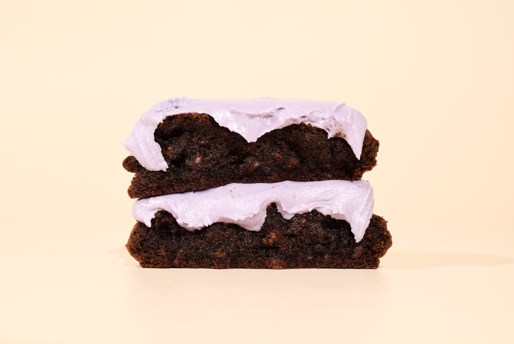 two stacked ghoulberry cookies on a cream background