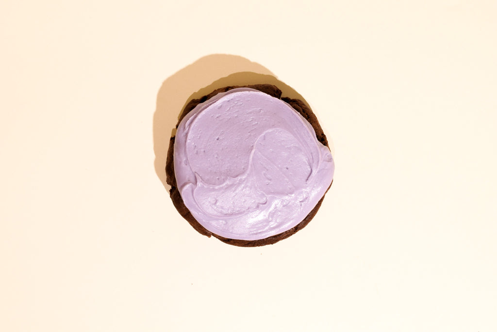 A chocolate blackberry cookie on a cream background
