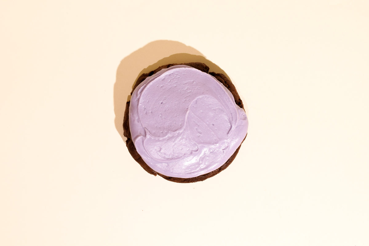 A chocolate blackberry cookie on a cream background