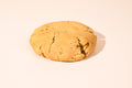 A Pralines & Cream cookie on a cream background.