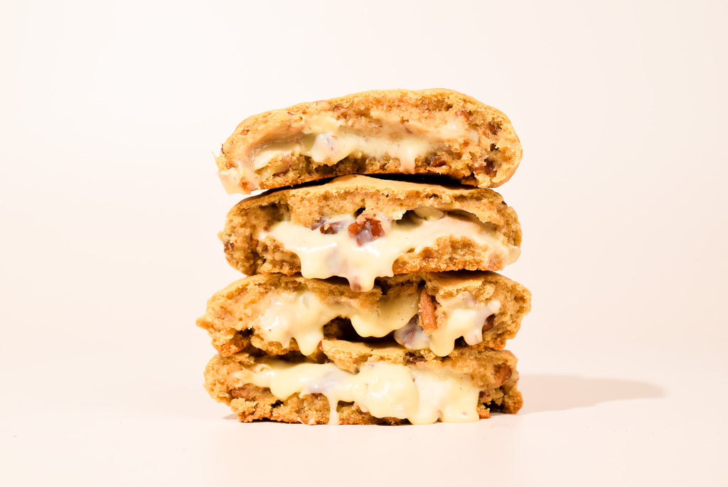 Pralines & Cream cookies stacked on a cream background.