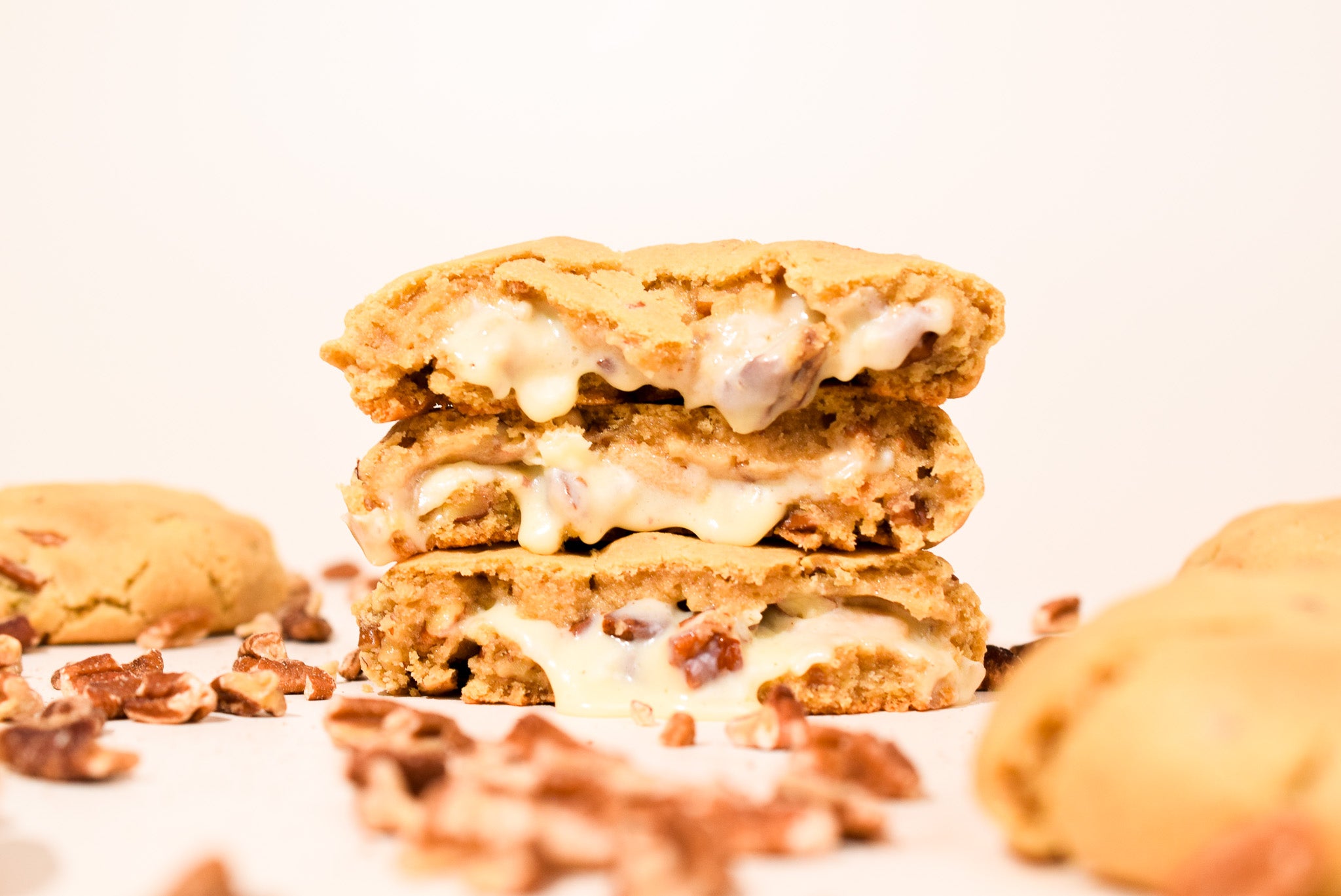 Pralines & Cream cookies stacked on a cream background.
