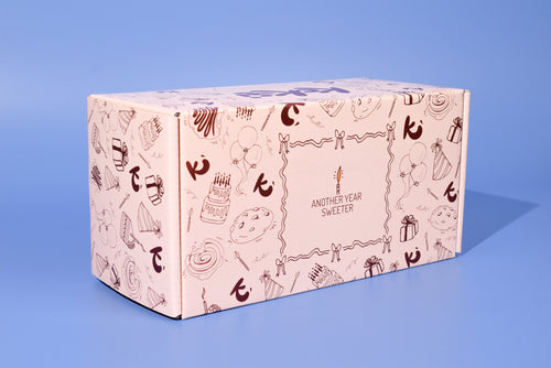 A birthday cookie box on a blue background.