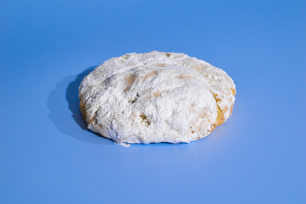 A Sugar Lemon cookie on a blue background.