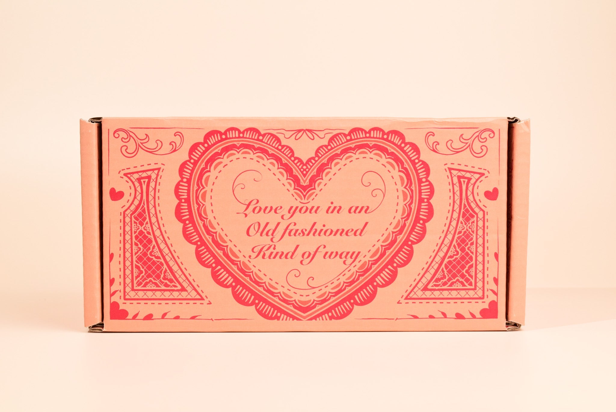 An image of the valentines day cookie box on a cream background.
